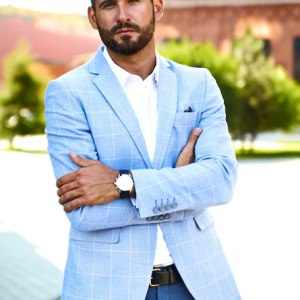 portrait-sexy-handsome-fashion-businessman-model-dressed-elegant-blue-suit-posing-street-background-metrosexual_158538-10546